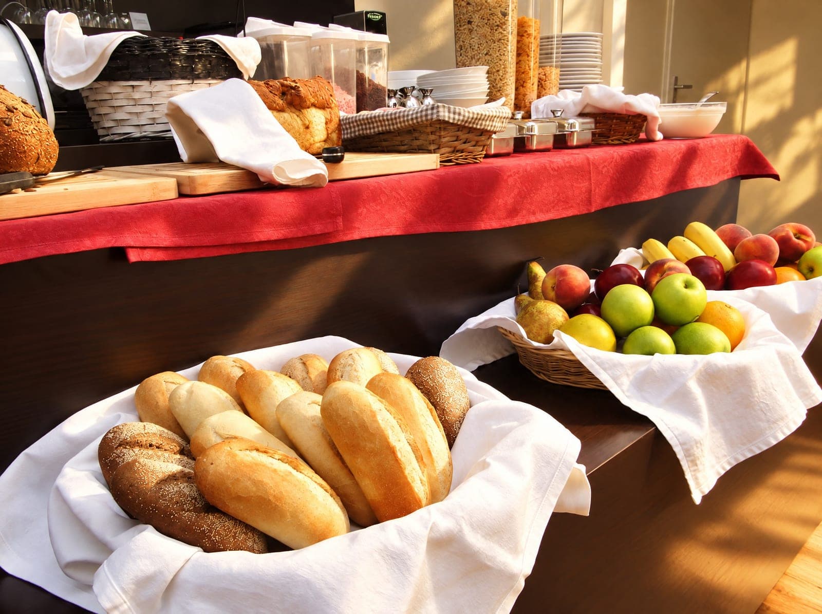Manden met vers brood en appels op het ontbijtbuffet
